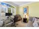 Bright home office with large windows and comfortable seating, perfect for remote work at 3597 Old Maple Rd, Johns Creek, GA 30022