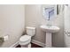 Powder room with pedestal sink and white fixtures at 4899 Seldon Se Way, Smyrna, GA 30080
