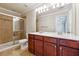 Bathroom featuring double sinks, wood cabinets, large mirror, and glass enclosed tiled shower at 4899 Seldon Se Way, Smyrna, GA 30080