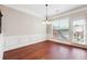 Elegant dining room with hardwood floors, wainscoting, chandelier and large window at 4899 Seldon Se Way, Smyrna, GA 30080