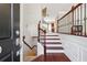 Inviting foyer with hardwood floors, a staircase, and elegant wrought iron railing at 4899 Seldon Se Way, Smyrna, GA 30080