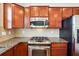 Close up of the kitchen with stainless steel appliances, granite countertops and cherry wood cabinets at 4899 Seldon Se Way, Smyrna, GA 30080