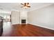 Open-concept living space with hardwood floors, fireplace, and a seamless flow to the adjacent rooms at 4899 Seldon Se Way, Smyrna, GA 30080