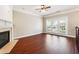 Bright living room featuring a fireplace, hardwood flooring, and large windows for ample natural light at 4899 Seldon Se Way, Smyrna, GA 30080