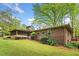 Brick home exterior highlighting the sunroom and landscaped backyard at 1061 Pathfinder Rd, Marietta, GA 30066
