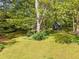 Lush backyard featuring mature trees and a charming shed at 1061 Pathfinder Rd, Marietta, GA 30066
