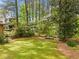 Beautifully landscaped backyard surrounded by mature trees offering privacy at 1061 Pathfinder Rd, Marietta, GA 30066