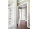 Bright bathroom showcasing a bathtub with shower, tiled walls, and open doorway to a hallway at 1061 Pathfinder Rd, Marietta, GA 30066