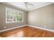 Inviting bedroom with hardwood floors and ample natural light from the large window at 1061 Pathfinder Rd, Marietta, GA 30066