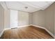 Cozy bedroom featuring hardwood floors, neutral paint, and bright natural light at 1061 Pathfinder Rd, Marietta, GA 30066