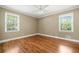 Bright and airy bedroom with hardwood floors and two windows offering natural light at 1061 Pathfinder Rd, Marietta, GA 30066