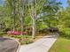 Lovely brick home with well-maintained landscaping, mature trees, and a long driveway, showcasing curb appeal at 1061 Pathfinder Rd, Marietta, GA 30066