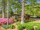 Charming brick home nestled among mature trees and vibrant landscaping, creating a peaceful and private setting at 1061 Pathfinder Rd, Marietta, GA 30066