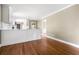 Bright kitchen showcasing white cabinets, stainless appliances, and gleaming hardwood flooring at 1061 Pathfinder Rd, Marietta, GA 30066