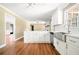 Open-concept kitchen with stainless steel appliances, white cabinets, and hardwood floors at 1061 Pathfinder Rd, Marietta, GA 30066