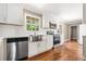 Bright kitchen with white cabinetry, stainless steel appliances, and hardwood flooring at 1061 Pathfinder Rd, Marietta, GA 30066