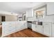 Charming kitchen features white cabinets, stainless steel appliances, and hardwood floors at 1061 Pathfinder Rd, Marietta, GA 30066