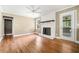 Spacious living room with a white brick fireplace, hardwood floors, and natural light at 1061 Pathfinder Rd, Marietta, GA 30066
