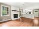 Inviting living room featuring a fireplace, hardwood floors, and seamless flow into the kitchen area at 1061 Pathfinder Rd, Marietta, GA 30066
