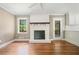 Living room featuring a white brick fireplace, hardwood floors, and a bright window at 1061 Pathfinder Rd, Marietta, GA 30066