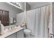 A traditional bathroom features a single sink vanity, neutral finishes, and a shower with a patterned curtain at 1180 Brookhaven Park Ne Pl, Brookhaven, GA 30319