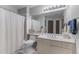 This bathroom features a shower with a curtain, a single sink vanity, and a large mirror at 1180 Brookhaven Park Ne Pl, Brookhaven, GA 30319