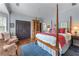 A spacious main bedroom boasts a four-poster bed, a sitting area, hardwood flooring, and abundant natural light at 1180 Brookhaven Park Ne Pl, Brookhaven, GA 30319