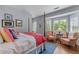 A luxurious main bedroom showcases natural light through bay windows, a four-poster bed, and hardwood flooring at 1180 Brookhaven Park Ne Pl, Brookhaven, GA 30319