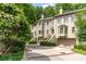 Elegant townhome exterior showcasing well-maintained landscaping and attached garages at 1180 Brookhaven Park Ne Pl, Brookhaven, GA 30319