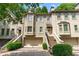 Attractive townhome exterior with a two-car garage, private entrances, and well-maintained landscaping at 1180 Brookhaven Park Ne Pl, Brookhaven, GA 30319