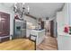 Charming kitchen featuring stainless steel appliances, white cabinetry, and a central island cooktop at 1180 Brookhaven Park Ne Pl, Brookhaven, GA 30319