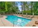 Community pool featuring multiple lounge chairs, well-maintained landscaping and a secure enclosure at 1180 Brookhaven Park Ne Pl, Brookhaven, GA 30319