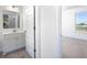 Bathroom with modern sink and vanity, with view to next room at 13250 Tolstoy Dr, Covington, GA 30014