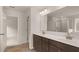 Bathroom featuring a double vanity, framed mirror and large walk-in shower at 13250 Tolstoy Dr, Covington, GA 30014