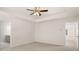 Spacious bedroom featuring a modern ceiling fan and neutral carpeting at 13250 Tolstoy Dr, Covington, GA 30014
