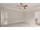 Bright bedroom with a modern ceiling fan and neutral carpeting at 13250 Tolstoy Dr, Covington, GA 30014