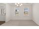 Spacious dining room with plush carpeting, perfect for entertaining at 13250 Tolstoy Dr, Covington, GA 30014
