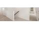 Upstairs hallway with neutral walls, carpet, and access to multiple rooms at 13250 Tolstoy Dr, Covington, GA 30014