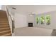 Spacious living room features a fireplace, staircase, and ample natural light at 13250 Tolstoy Dr, Covington, GA 30014