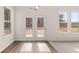 Bright living room features a double glass panel door and big windows at 13250 Tolstoy Dr, Covington, GA 30014