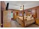 Comfortable bedroom with a wooden four-poster bed and matching dresser at 198 Wiley Dr, Douglasville, GA 30134