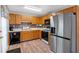 Well-equipped kitchen with stainless steel appliances, oak cabinets, and a stylish backsplash at 198 Wiley Dr, Douglasville, GA 30134
