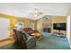 Cozy living room with a stone fireplace, comfortable seating, and a ceiling fan at 198 Wiley Dr, Douglasville, GA 30134