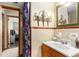 Vintage bathroom featuring unique decor, tiled walls, and a decorative mirror at 2044 Yucca Dr, Decatur, GA 30032