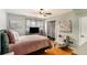 Comfortable bedroom featuring a plush bed, hardwood floors, and natural light from the window at 2044 Yucca Dr, Decatur, GA 30032