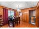Inviting dining space featuring a chandelier, hardwood floors, and wood-paneled walls at 2044 Yucca Dr, Decatur, GA 30032