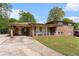 Charming brick home featuring a covered carport, a cozy front porch, and a well-maintained front yard at 2044 Yucca Dr, Decatur, GA 30032