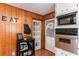 Charming kitchen area with wood paneling, stainless steel appliances, and decorative 'EAT' lettering at 2044 Yucca Dr, Decatur, GA 30032