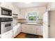 Bright kitchen featuring white cabinetry, laminate countertops, and ample natural light at 2044 Yucca Dr, Decatur, GA 30032