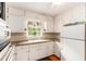 Functional kitchen with white cabinets, granite countertops, stainless sink and hardwood floors at 2044 Yucca Dr, Decatur, GA 30032